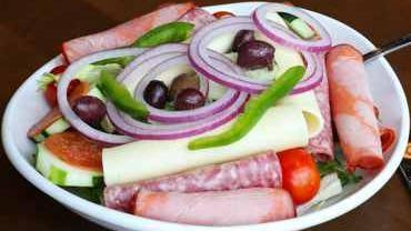 Antipasto Salad · Genoa salami, capicola ham, pepperoni, Kalamata olives, peppers, onions, fresh vegetables and provolone cheese, served on a bed of mixed greens.