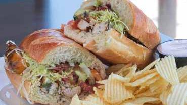 California Chicken Sub · Grilled chicken breast topped with bacon, avocado, red onion, lettuce, tomato, cucumber and Cheddar cheese, served with a side of chipotle ranch.