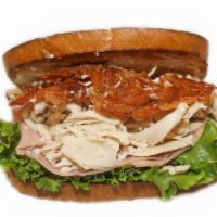 Turkey Ham Club Sandwich · Carved Oven Baked Turkey Breast, Carved Ham with cheese, toppings on a choice of bread.