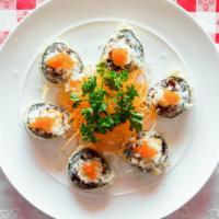 Sp22. O.M.G Roll · Tempura fried salmon, crabmeat, white fish, topped with tobiko, chef sauce, and crunchy temp...