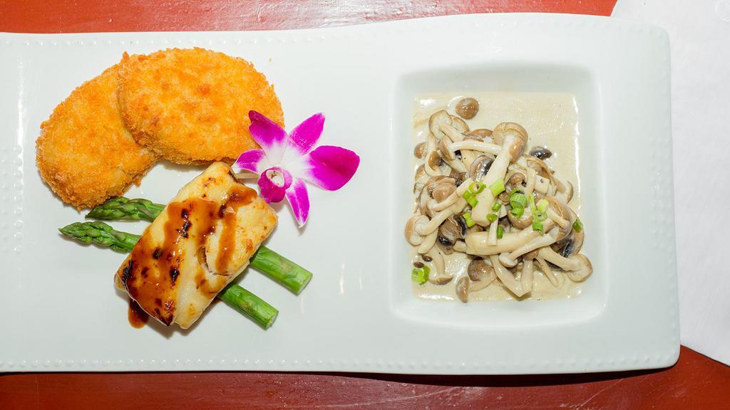 Miso Cod · Miso marinated cod served with sautéed mushrooms, asparagus, and korokke.