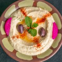 Hummus · Vegetarian. Rich purée of chickpea and tahini, olive oil, lemon juice, and fresh herbs.