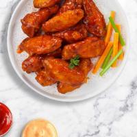Baffling Buffalo Wings · Fresh chicken wings breaded, fried until golden brown, and tossed in buffalo sauce. Served w...