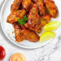 Sweet Chili Symphony Wings · Fresh chicken wings breaded, fried until golden brown, and tossed in sweet chili sauce. Serv...