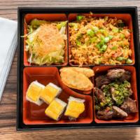 Dominican Bento Box · Churrasco, chocan, cibao roll, salad and dumpling