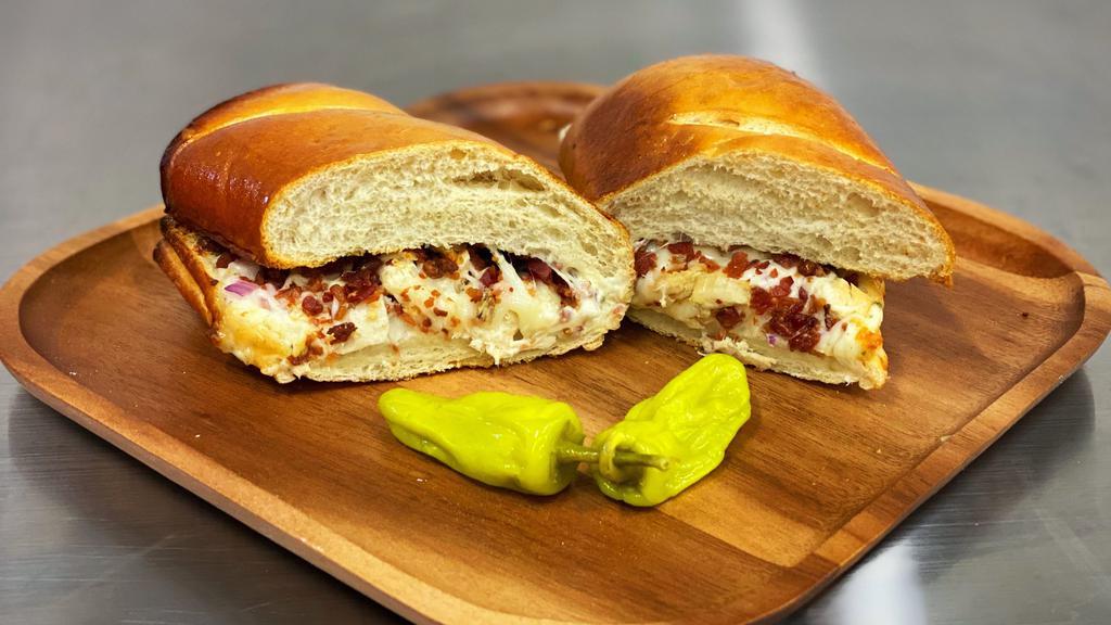 Chicken Bacon Ranch Sub · French bread, mozz, chicken, bacon bits, red onion & ranch sauce.