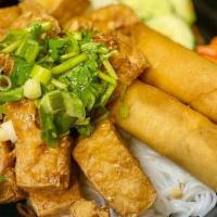 Lucky Buddha Bowl · Grilled tofu, vegetables crispy rolls, lettuce, chilled vermicelli, cucumber, carrot & daiko...