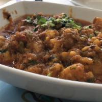 Aloo Gobi · Potatoes and cauliflower cooked with fresh tomatoes, onions, and spices.