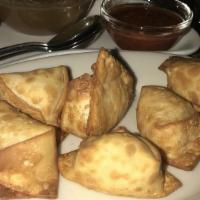 Crab Rangoon · Crab and Cream Cheese won ton  pinched Into little purses and fried till crisp