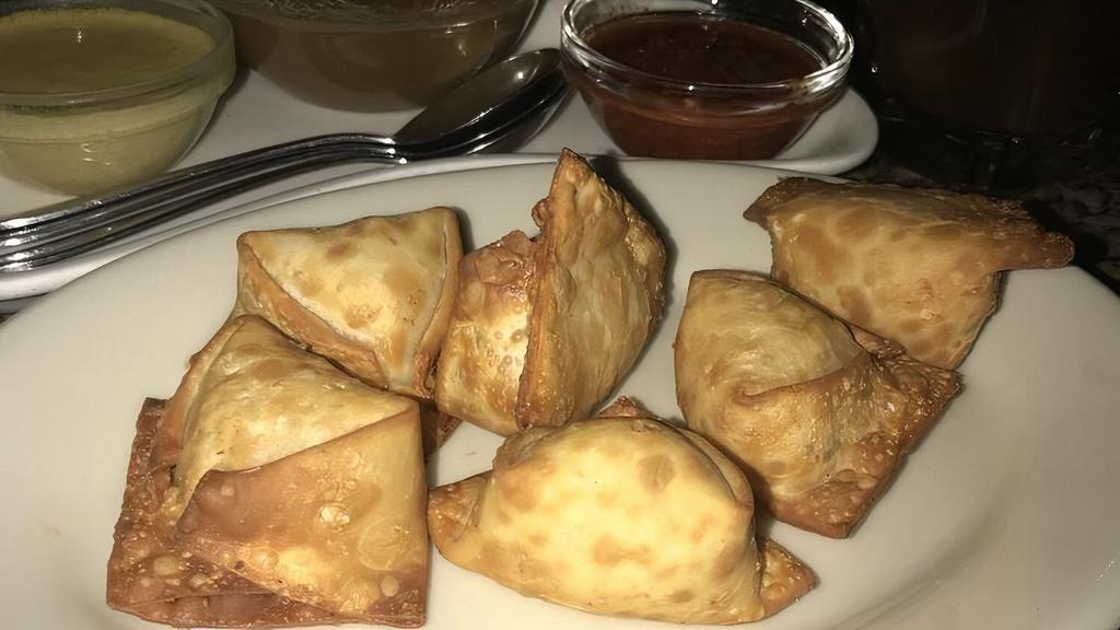Crab Rangoon · Crab and Cream Cheese won ton  pinched Into little purses and fried till crisp