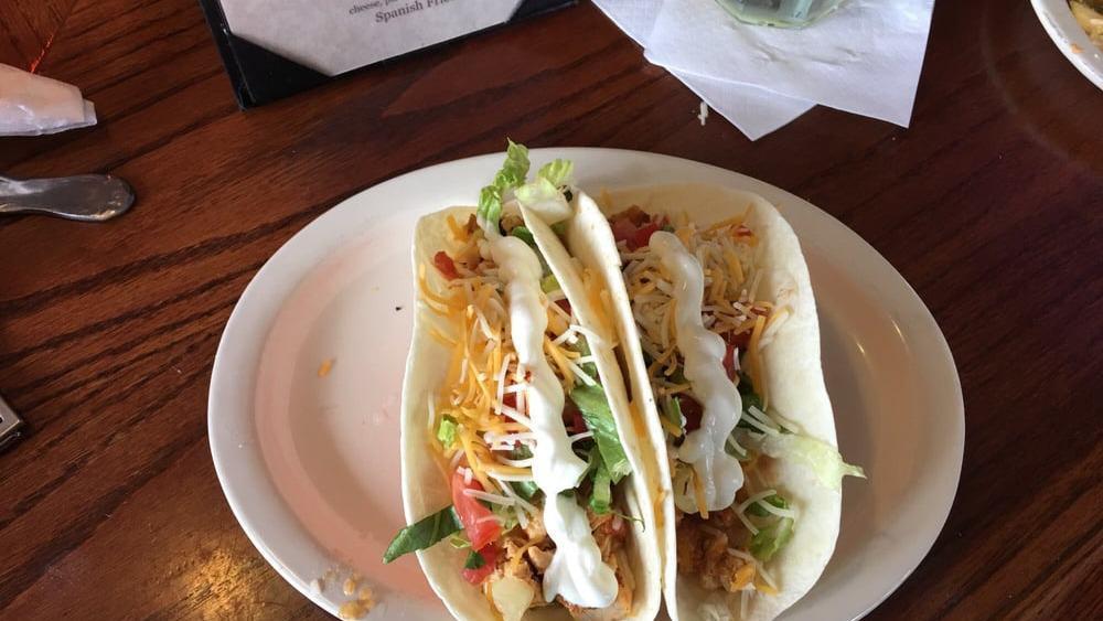 Soft Chicken Tacos · Three soft flour tacos, tender seasoned chicken breast, cheese, lettuce, tomato, and Mexican crème. Served with red rice and pinto beans.
