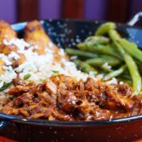 Chipotle Peanut Bbq Pulled Pork · Tender pulled pork, chipotle peanut BBQ sauce, poblano spinach rice, and fried sweet plantai...