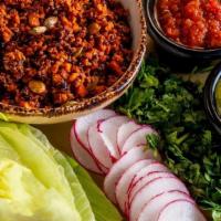 Lettuce Wraps · Plant-based chorizo mixed with red quinoa and pepitas served with radish, cilantro, Fire Roa...