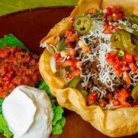 Taco Salad · Spicy taco beef, pico de gallo, roasted peppers, onions, jalapenos, and cheese heaped over i...
