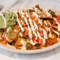 Nachos Libres · Tortilla chips topped with refried beans, melted chihuahua cheese, guacamole, sour cream and...