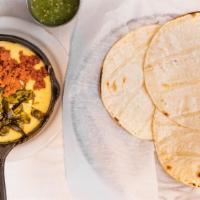 Queso Fundido · Chihuahua cheese melted, served sizzling hot with corn or flour tortillas, choice of salsa.