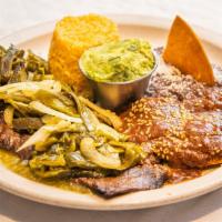 Carne Tampiqueña · 9 oz grilled skirt steak topped with poblano peppers, served with guacamole cheese mole ench...