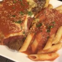 Veal Parmigiana · Breaded veal cutlet topped with mozzarella and tomato sauce.