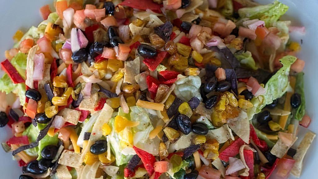 Chipotle Chopped Salad · Romaine tossed in chipotle ranch with roasted corn, Pico de Gallo, shredded cheese, avocado, black beans and crunchy tortilla strips.