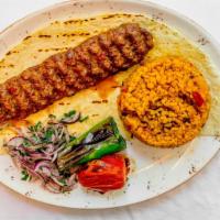 Adana Kebap · Char-grilled ground beef and lamb kebap seasoned with red peppers and spices served with bul...