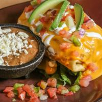 Cheesy Chimichanga · Deep-fried burrito filled with chicken or beef, Mexican rice, and queso, topped with sour cr...