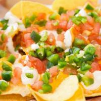 Nachos · Corn chips served with your choice of melted cheese or queso, pico de gallo, jalapeños, and ...