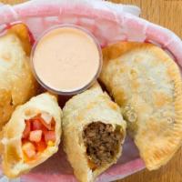 Empanada (1 Per Order) · Delicious Spanish-style turnover filled with cheese and your choice of beef, chicken, or veg...