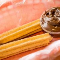 Churros · Mexican pastry sprinkled with cinnamon and sugar, served with a side of Nutella