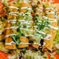 Taquitos Mexicanos · Two beef and two chicken fried corn taquitos topped with lettuce, guacamole, sour cream and ...