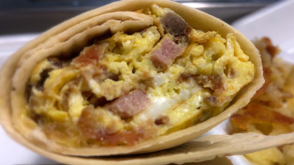 Meat Lover'S Breakfast Wrap · Scrambled eggs mixed with ham, bacon, sausage, and scrapple in a flour tortilla.