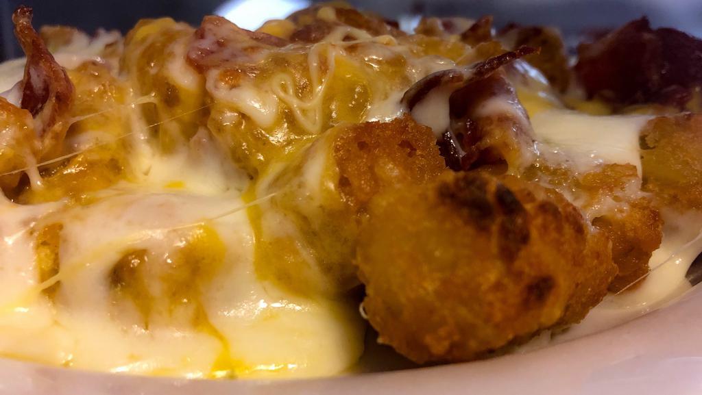Loaded Tots · Tater tots loaded with melted cheese and bacon.