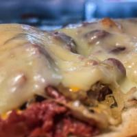 Reuben Sandwich · Grilled corned beef served open-faced with sauerkraut, Russian dressing, and Swiss cheese.