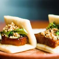 Braised Pork Belly Bao · pickled cucumbers, candied sunflower seeds, cilantro