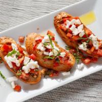 Bruschetta · Toasted bread topped with bruschetta tomatoes, mozzarella cheese, olive oil, and basil.