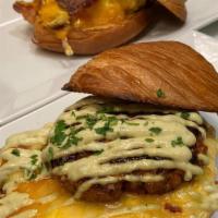 Chateau Sandwich · Scrambled egg, goat cheese, spinach, and hollandaise sauce on a toasted croissant bun.