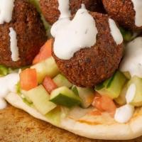 Falafel Gyro · Seasoned fried falafel with lettuce, tomato, onion in a pita with choice of white, red, and ...