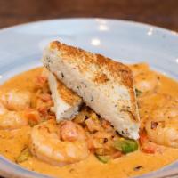 Shrimp & Grits · 5 tail on shrimp, tomatoes, roasted corn, asparagus, shallots, cajun cream sauce and crab gr...