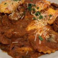 Ravioli Sorrento · Traditional cheese ravioli with sautéed sweet Italian sausage and mushrooms in a spicy tomat...