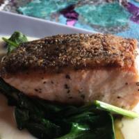 Pan Seared Salmon · Crispy skin, spinach, Parmesan cream.