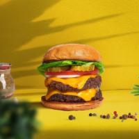 Cloned Cheese Burger · Two seasoned plant-based patties topped with melted vegan cheese, lettuce, tomato, onion, an...