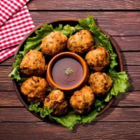  Batter Fry Vegetable · Delicately spiced fried fritters lightly battered in chickpea flour. Served with cilantro an...