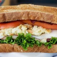 Thanksgiving Sandwich · Fresh sliced turkey, cranberry sauce, stuffing, lettuce, and tomato with bagel chips and pic...