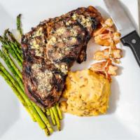 Steak La Patrona · 16 oz ribeye served with butterflied shrimp and topped with garlic butter. Served with chipo...