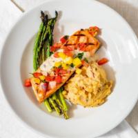 Tropical Salmon · Grilled salmon in a tequila sauce served over chipotle mashed potatoes, topped with pineappl...