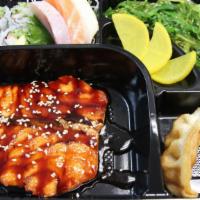Salmon Bento Box · A combination of sashimi, salmon, California maki, seaweed salad, gyoza and shumai. Served w...