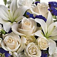 Teleflora'S Sapphire Skies Bouquet · Crème roses, white Asiatic lilies and white miniature carnations are mixed with bursts of pu...