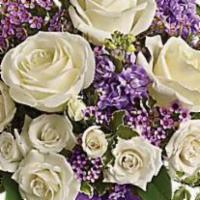 Teleflora'S Enchanted Cottage · White roses and spray roses, lavender stock and waxflower, all perfectly arranged in a clear...