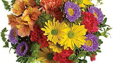 Make A Wish · Yellow daisy spray chrysanthemums, purple Matsumoto asters, red miniature carnations, orange carnations and alstroemeria - accented with bupleurum - are delivered in a miniature ginger vase adorned with a plaid green ribbon.