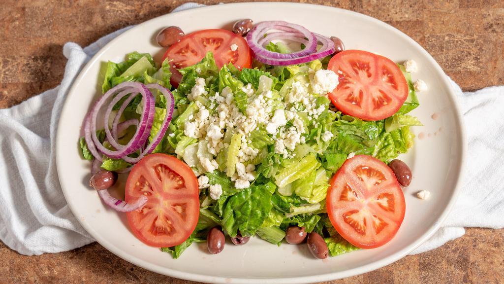 Greek Salad · Romaine, tomatoes, red onions, black olives, and feta cheese with garlic red wine vinaigrette.
