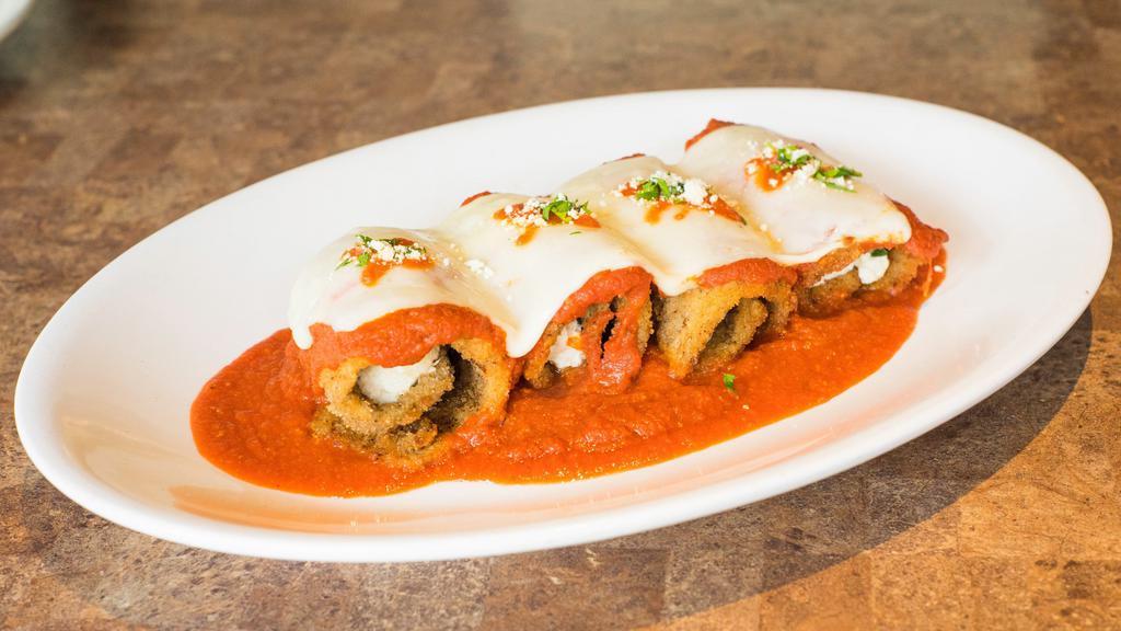 Rollatini Di Melanzane · Three cheeses surrounded by eggplant and baked to perfection with tomato sauce and topped with mozzarella cheese. Served with capellini.